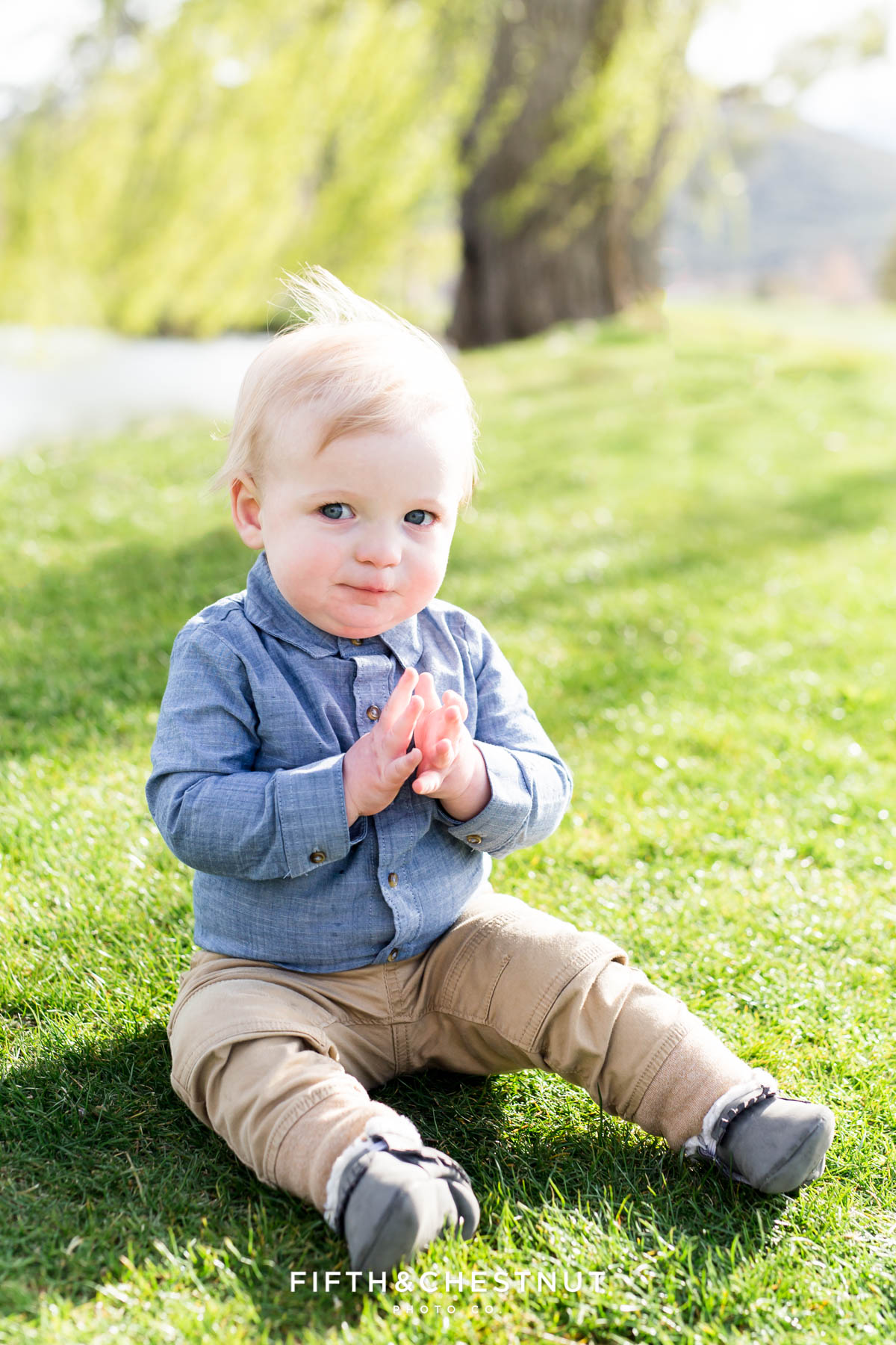 Baby boy looking mischievously at photographer for his Golf Themed One Year Photos by Reno Baby Photographer