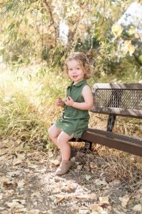 toddler sits on a bench at Oxbow Nature Study for photos by Reno Family Photographer