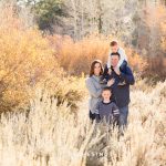 A family is backlit by the sun for Thomas Creek Portraits on a beautiful fall day.