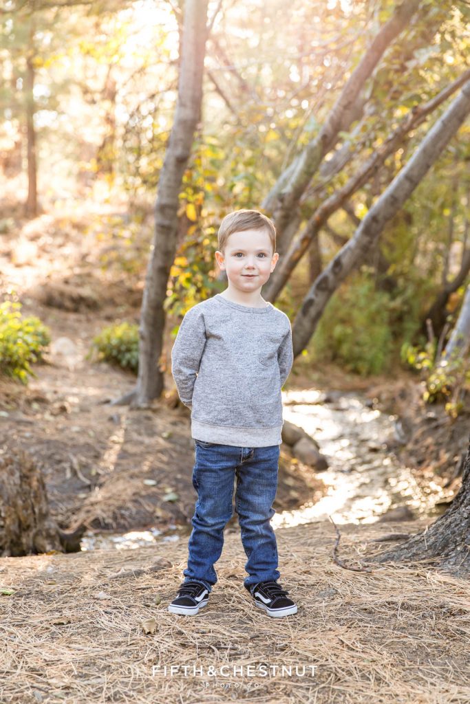 Portrait of a four year old boy in front of a beautiful creek