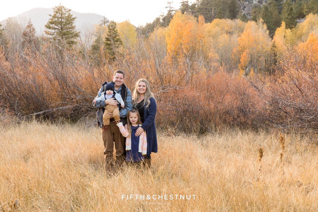 A family standing in a field of dry grasses for their Hope Valley family portraits by Hope Valley Photographer