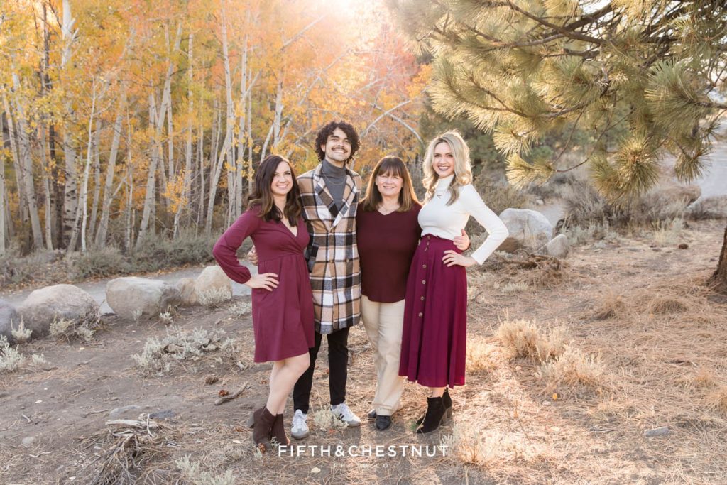 Golden Reno Fall Family Portraits of a mom and her three adult children wearing shades of burgundy, khaki and cream