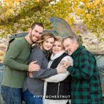 a family huddles together for a cute family portrait at barley ranch by reno family photographer