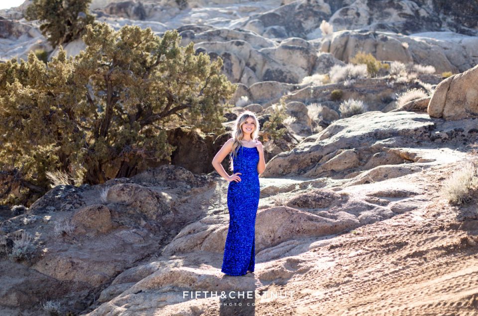 A striking portrait of a Reno High School Senior in a sequin royal blue dress during her high school senior portrait session by Reno Senior Photographer at Moon Rocks in Nevada