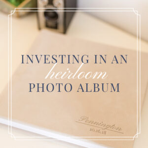A high-end photo album with custom debossing with a vintage camera in the background to showcase the benefits of investing in an heirloom-quality photo album