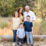 A gorgeous summer family portrait in Reno of a family wearing yellow, white and denim blue in a meadow by Reno Family Photographer