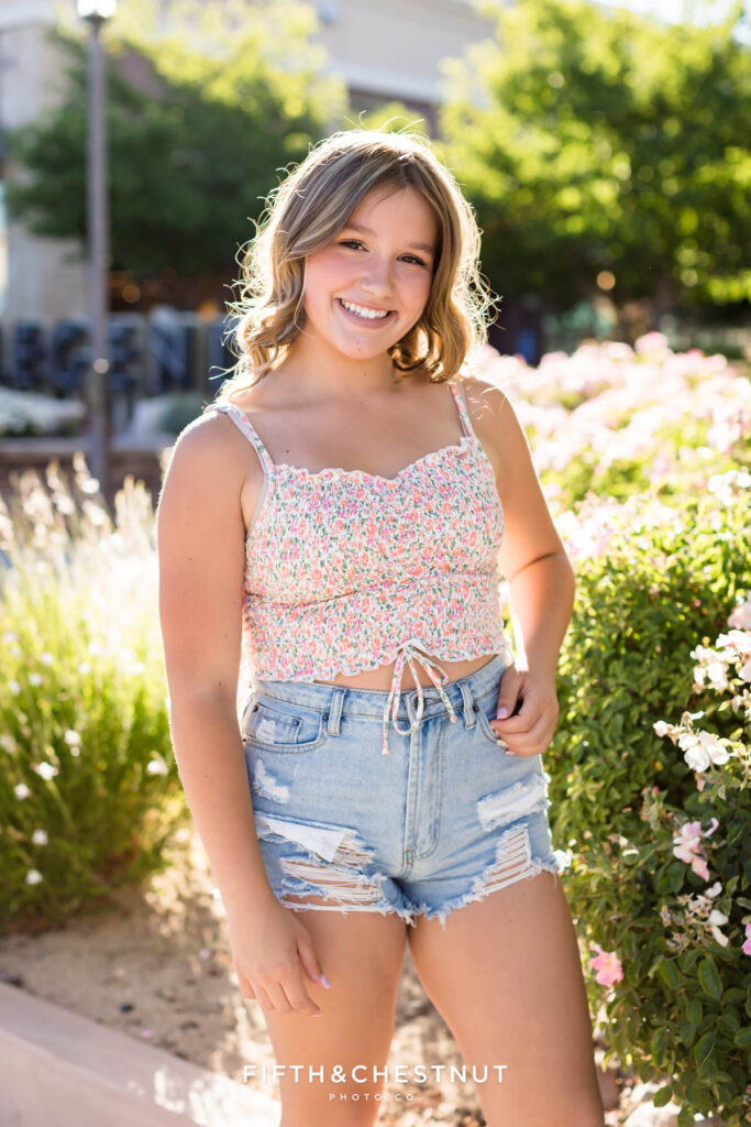 A beautiful summer portrait of a girl wearing a floral top and denim shorts by Reno Senior Photographer Fifth and Chestnut Photo Co.