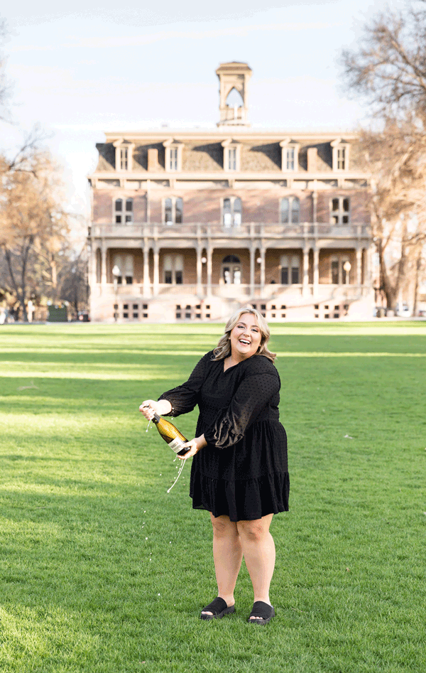 Gorgeous Spring UNR Grad Portraits of Jordan popping champagne on the quad 
by UNR Grad Photographer at University of Nevada Reno