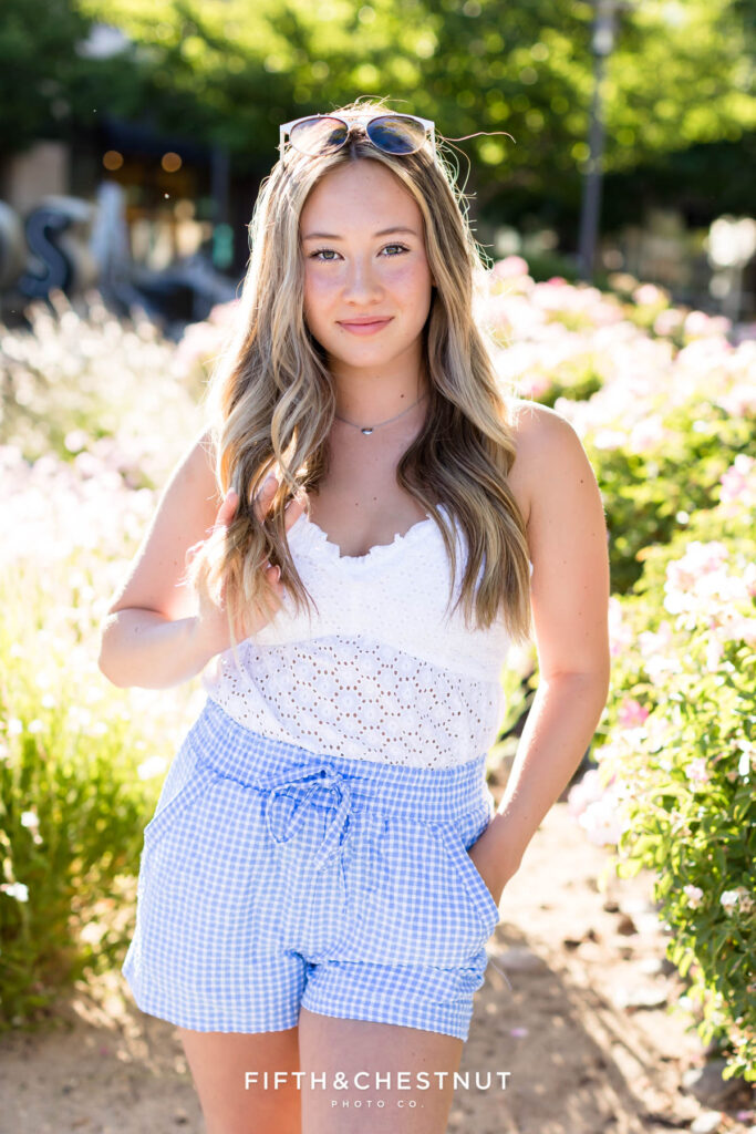 Summer Senior portraits in Sparks by Reno Senior Photographer with Payton, wearing blue gingham and a white eyelet top.