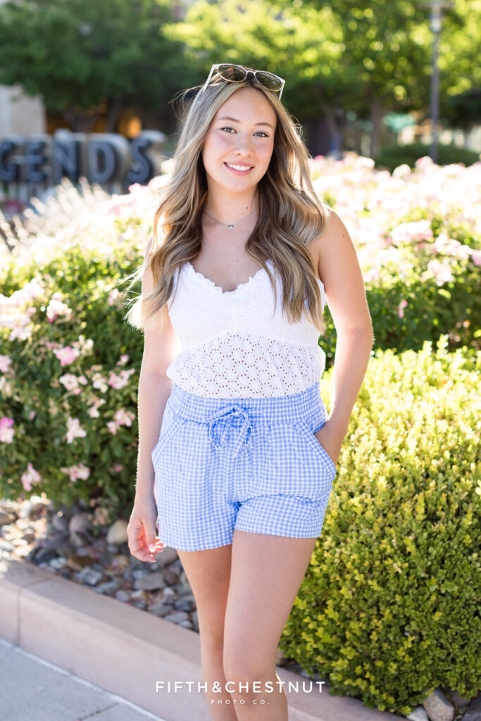 Summer Senior portraits in Sparks by Reno Senior Photographer with Payton, wearing blue gingham and a white eyelet top.