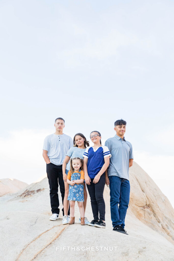 Moon Rocks Family Portraits with a family wearing light blue, gray and other neutral tones on a stunning summer evening with Reno Family Photographer.