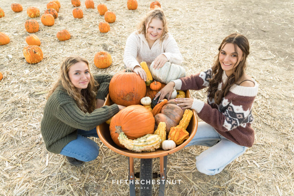 Class of 2024 Fifth and Chestnut Senior VIP Team Pumpkin Patch Portraits in Reno with Kenzie, Audrey and Natalie by Reno Senior Photographer at Ferrari Farms.