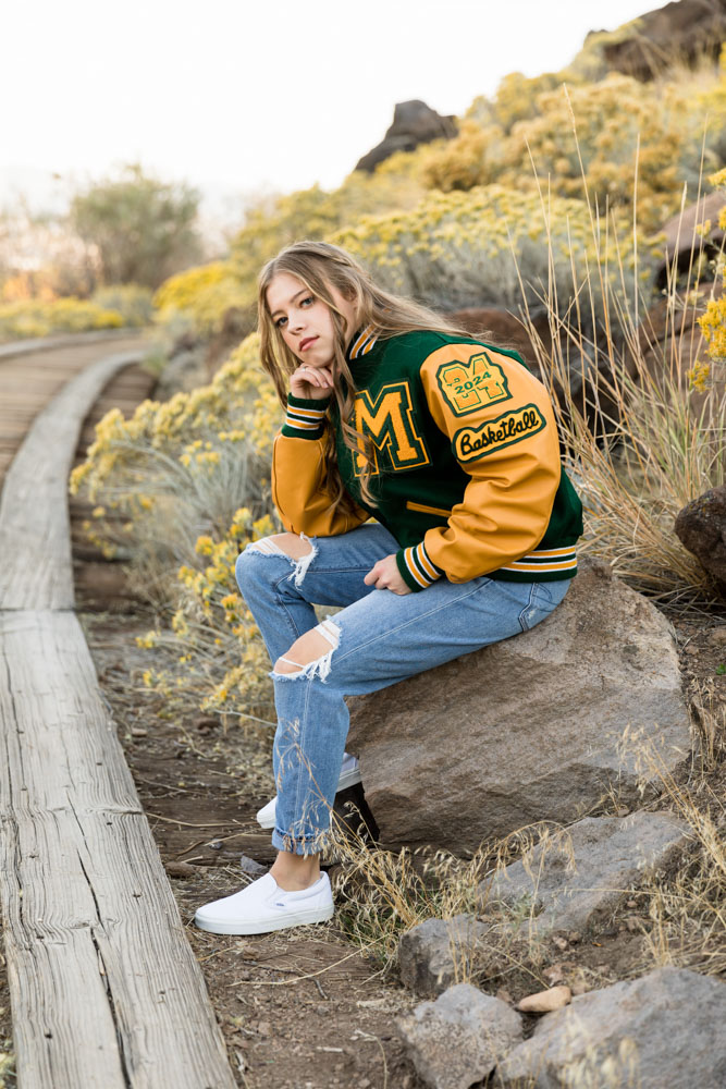 Bishop Manogue High School Senior Portrait showcasing a track and field and cross country letterman jacket at Bartley Ranch during the fall by Reno Senior Photographer.