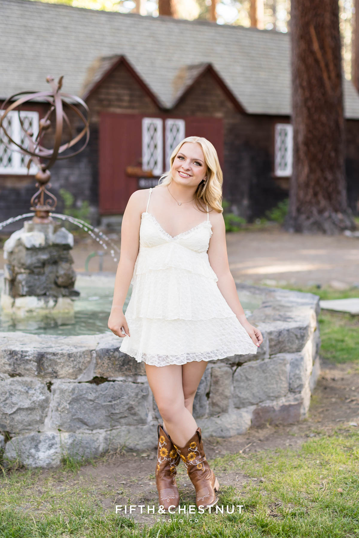 Reno High School Senior in a cream dress and cowboy boots at Tallac Historic Site