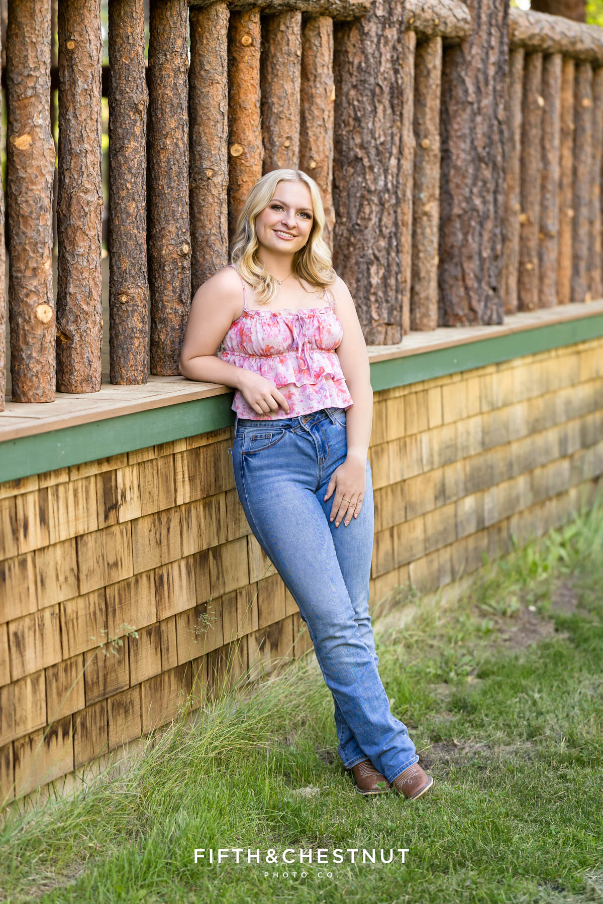 Reno High School Senior posing in jeans and a floral top at Valhalla