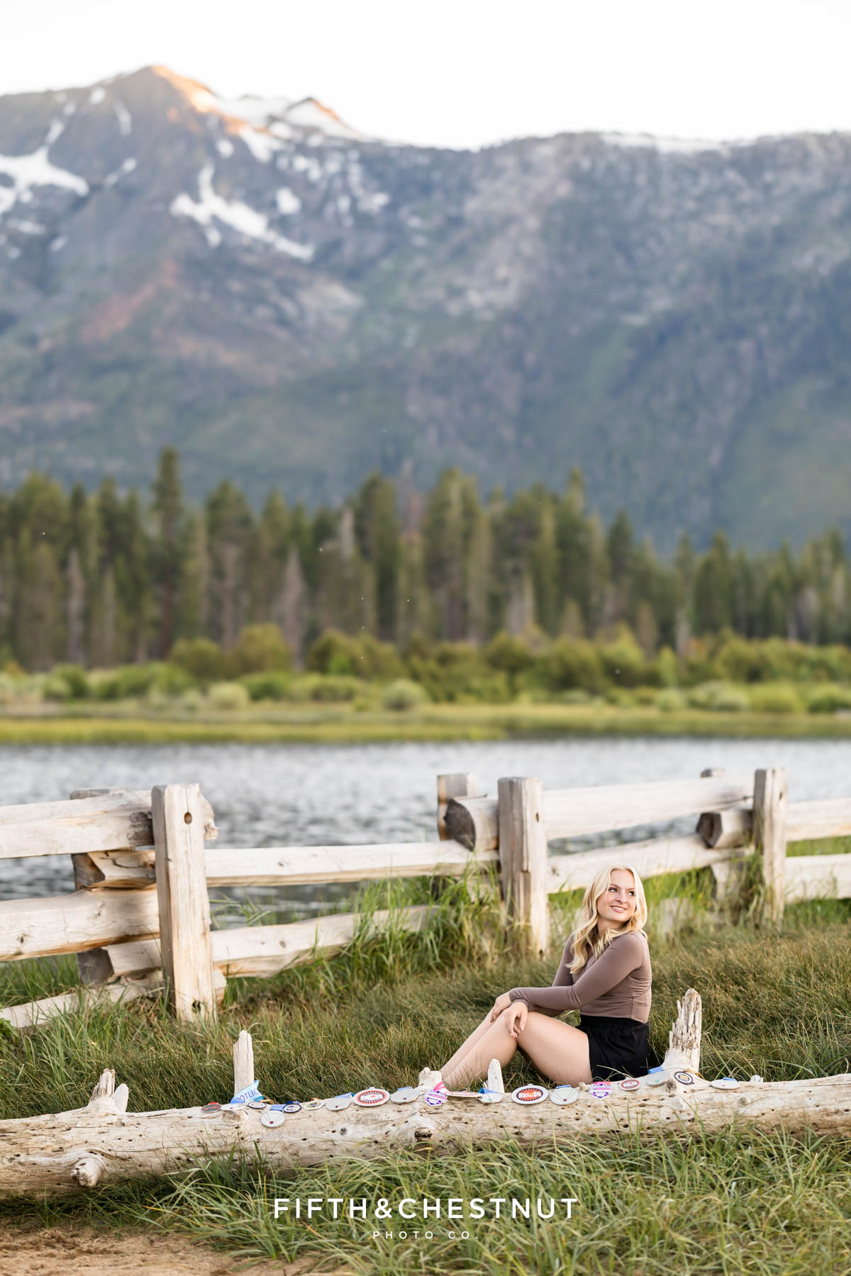 Reno High School Senior sitting in the grass near her dance medals at the beach