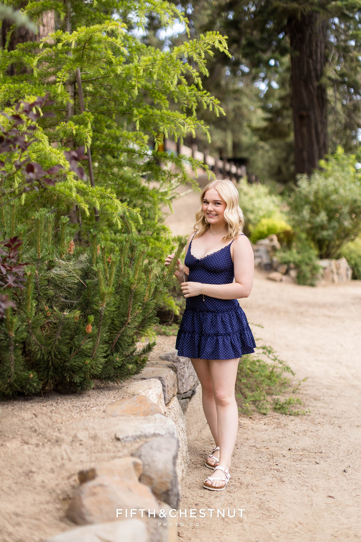 Bishop Manogue Senior posing on a forested trail in Incline Village for senior portraits