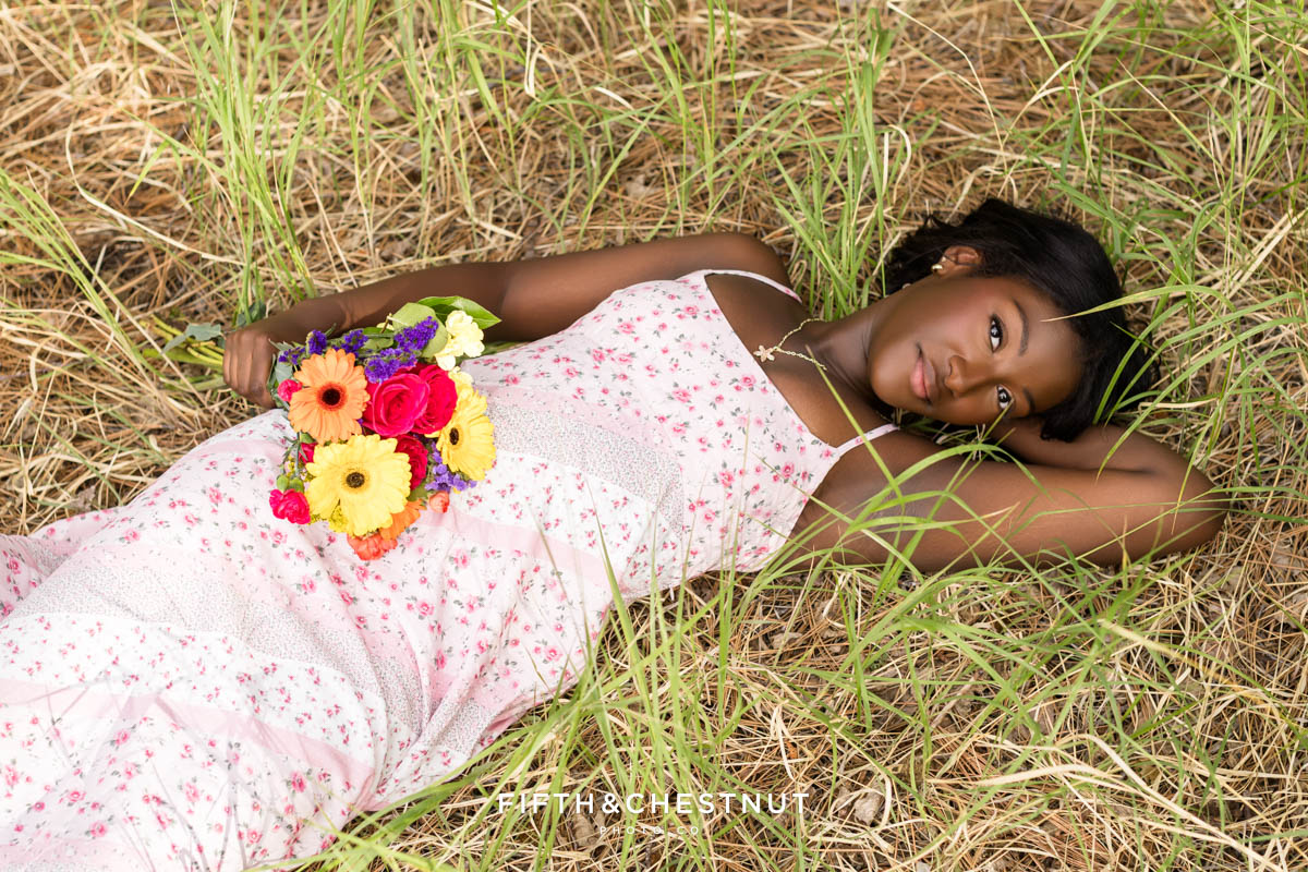 High school senior in pink sundress among summer blooms – flower farm senior photos in Reno/Tahoe