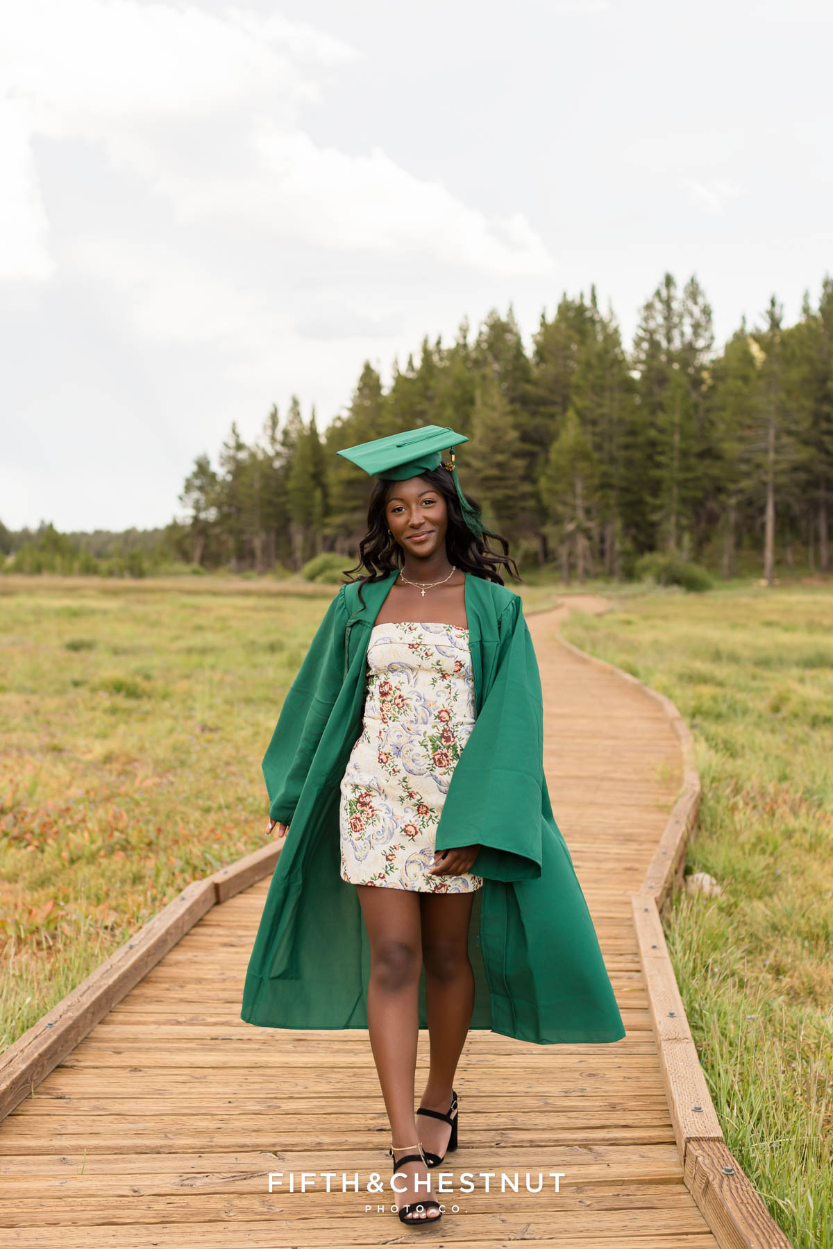Senior wearing cap and gown in Tahoe meadow above Incline Village – flower farm senior photos in Reno/Tahoe